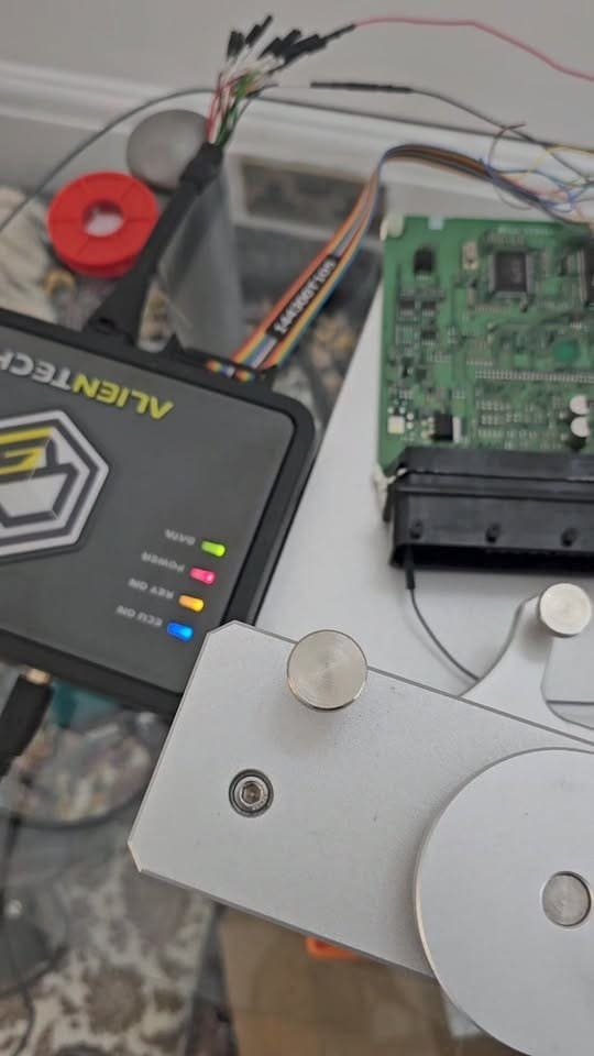 Engine ECU connected to programming tools on the bench at Pro Remapping